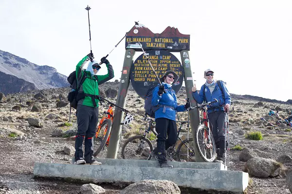 Bikers pausing during 5 days Kilimanjaro bike trekking tour via Marangu route