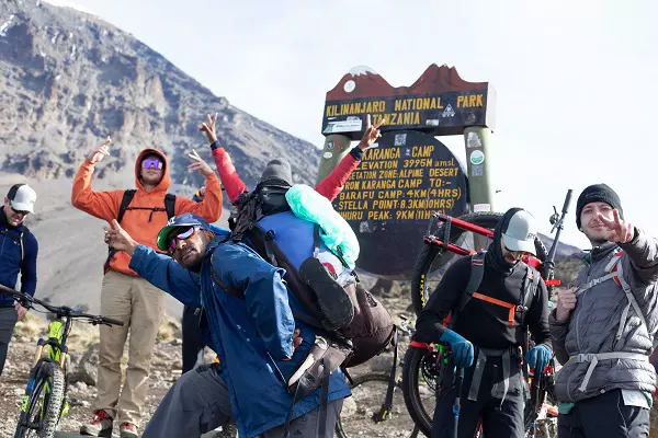 Bikers celebrating during 6 days Kilimanjaro bike trekking tour via Marangu route