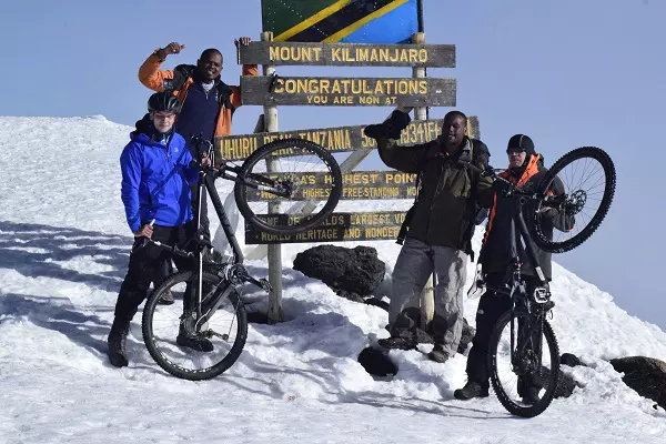 Celebrating Kilimanjaro Bike Trekking Tour on top of Mount Kilimanjaro